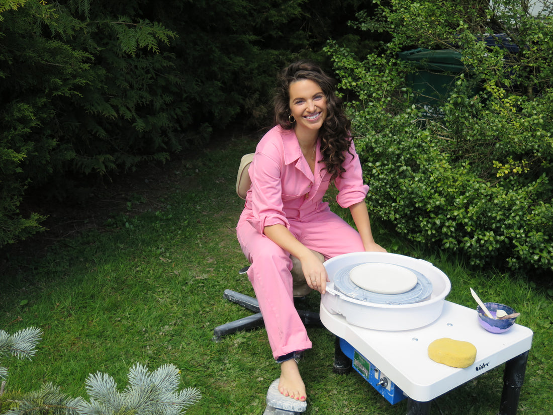 Chief Designer and CEO of Pottery by Eleni at the wheel outside our studio.