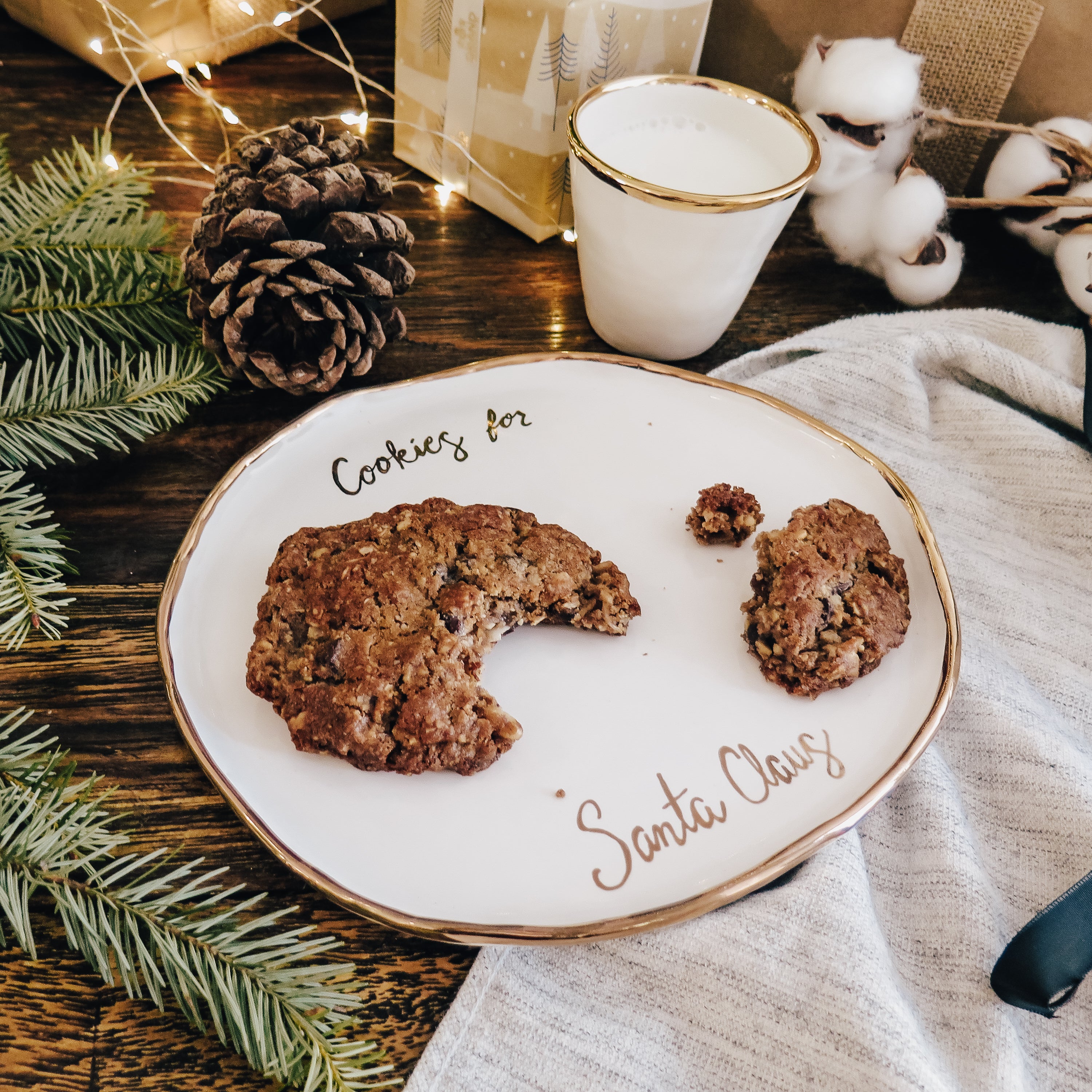 Top 45º view of the cookie plate, accompanied by a white and gold ceramic cup for drinking milk.