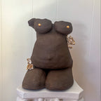 An straight-on view of the sculpture "She Who Carries".