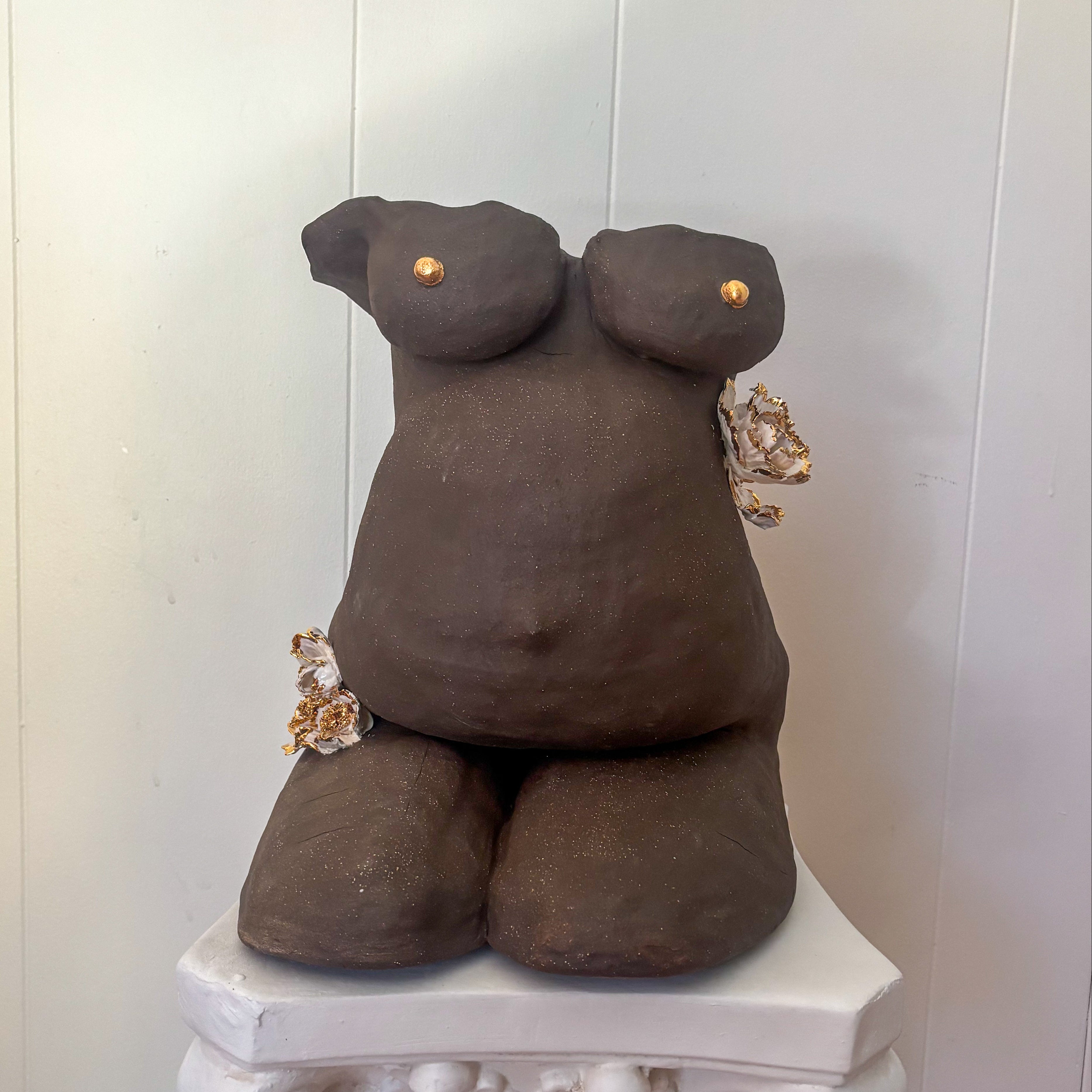 An straight-on view of the sculpture "She Who Carries".