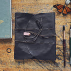 An overhead view of a hand-crafted, high-quality leather painter's palette "Mary Leather" wrap.