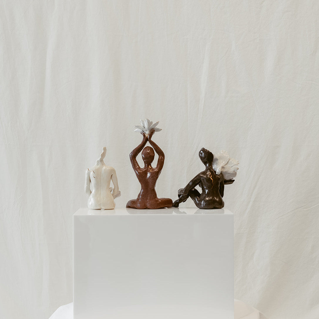 A straight-on view featuring the back of the piece: "She Who Gathers".