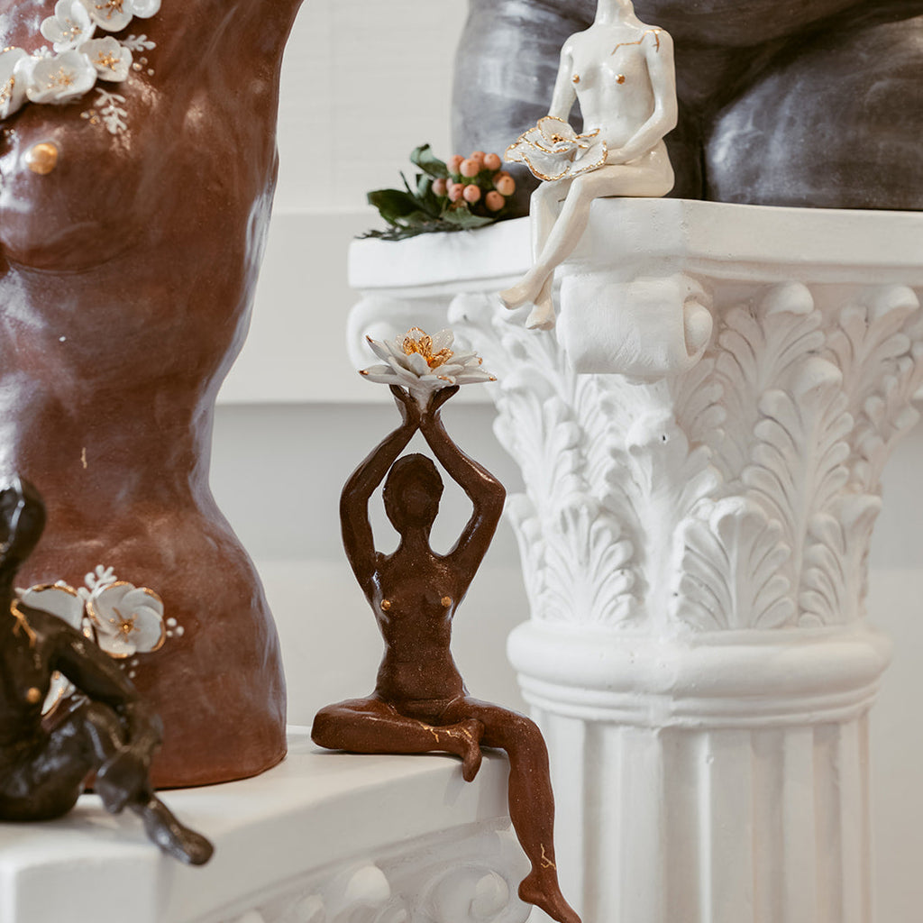 A close-up of the terracotta figurine of the piece, "She Who Gathers".